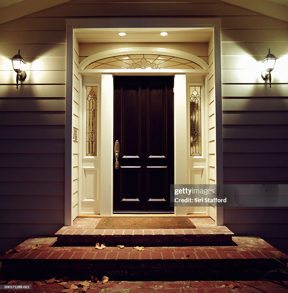Front door of house with lights at night