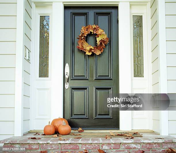 pumpkins on front step of house - autumn wreath stock pictures, royalty-free photos & images