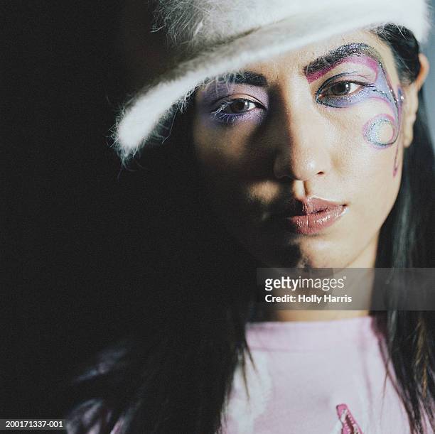 young woman wearing colorful face paint, portrait - stoneplus9 ストックフォトと画像