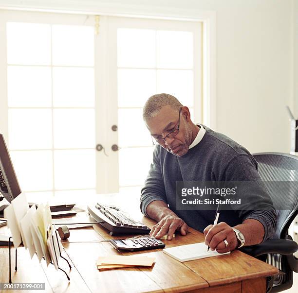 mature man working in  home office - study older man imagens e fotografias de stock