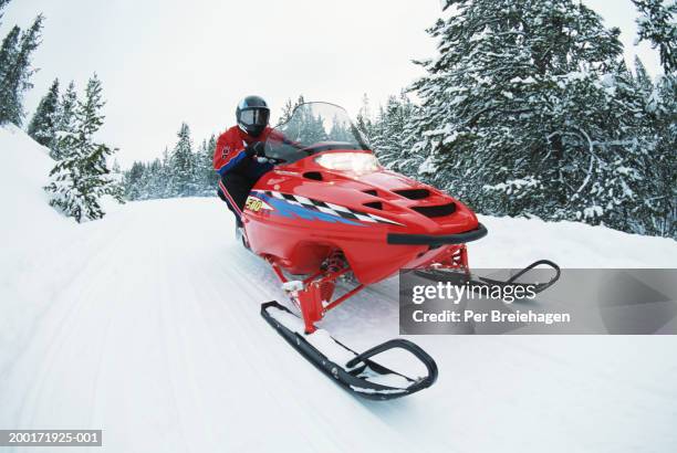 man on snowmobile, close-up - snowmobile stock pictures, royalty-free photos & images