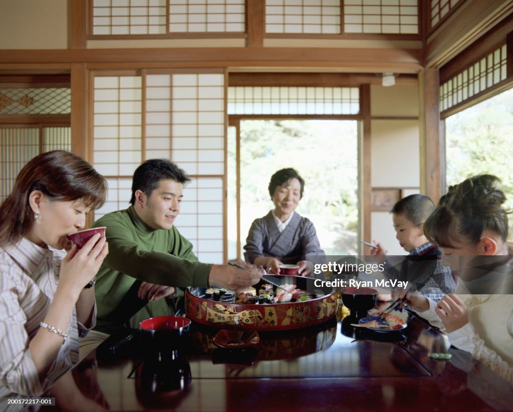 Three generation family eating sushi