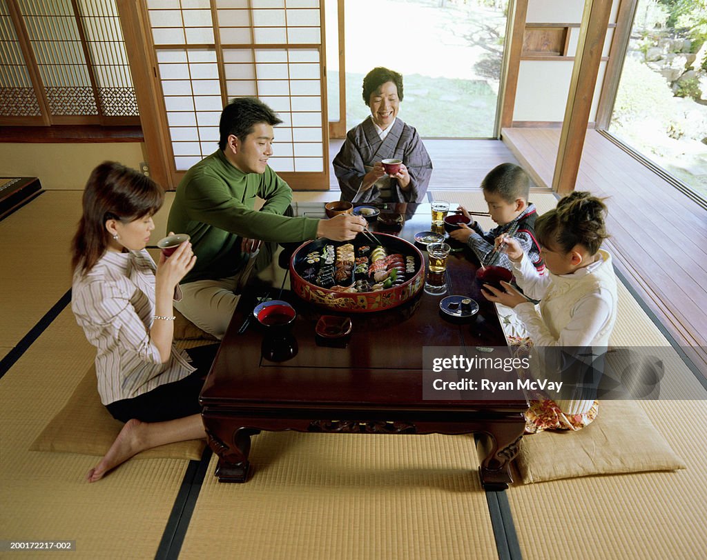 Three generation family eating sushi, elevated view