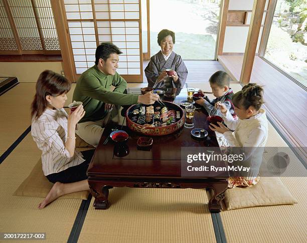 three generation family eating sushi, elevated view - tatami mat stock pictures, royalty-free photos & images