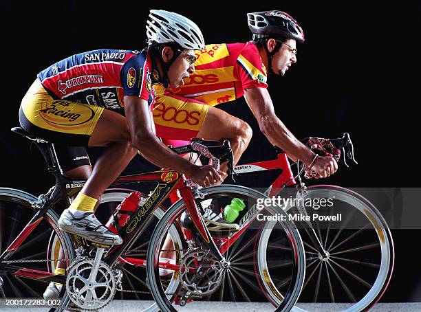 two male cyclist riding bicycles, side view - track cycling stock pictures, royalty-free photos & images