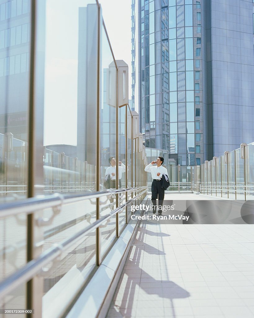 Mature businessman talking on cell phone in urban setting