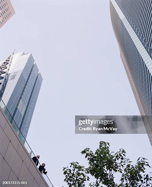 japan, tokyo, minato-ku, two businessmen outdoors, low angle view - nittele tower stock pictures, royalty-free photos & images