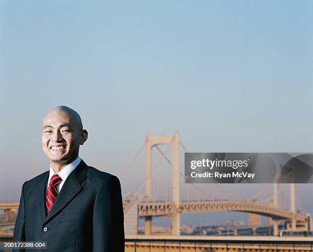 japan, tokyo, odaiba, young businessman near rainbow bridge, portrait - only japanese stock pictures, royalty-free photos & images