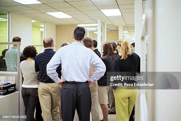 office workers having meeting, rear view - downsizing stock pictures, royalty-free photos & images