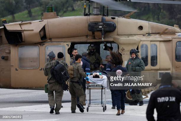 Graphic content / An Israeli medical team transports a peson wounded in a rocket attack fired from southern Lebanon at Ziv hospital in Israel's...