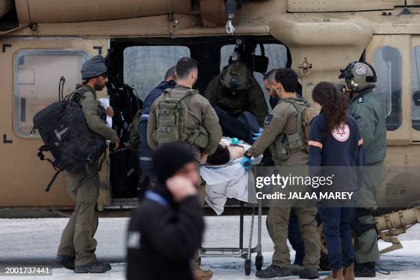 Graphic content / An Israeli medical team transports a peson wounded in a rocket attack fired from southern Lebanon at Ziv hospital in Israel's...