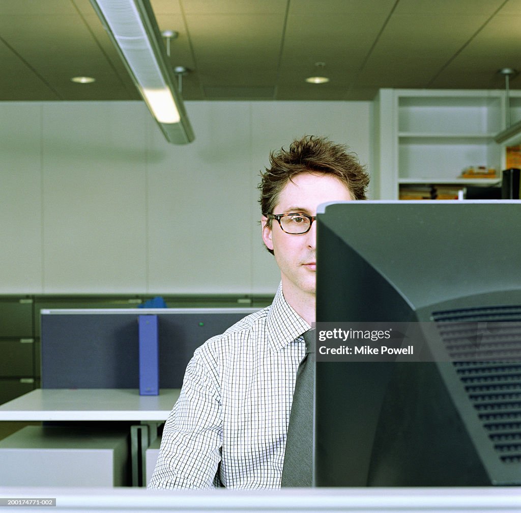 Businessman sitting in front of computer monitor