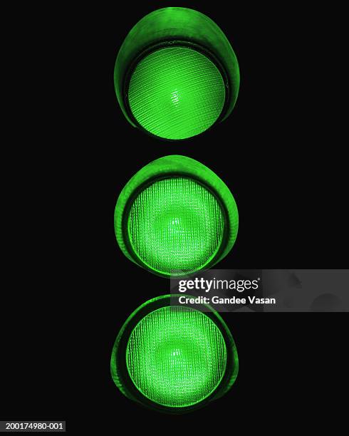 illuminated green traffic lights (digital enhancement) - ampel grün stock-fotos und bilder