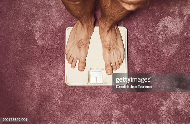 1,724 Man Standing On Scales Stock Photos, High-Res Pictures, and ...