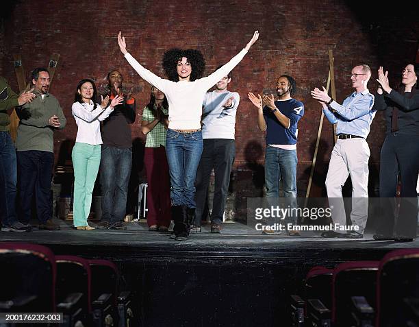 group of people on stage in theater applauding actor - schauspieler stock-fotos und bilder