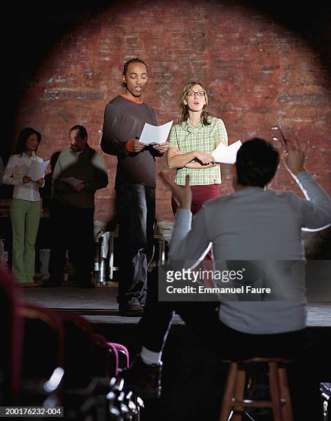 man and woman on stage auditioning with director - audition stockfoto's en -beelden
