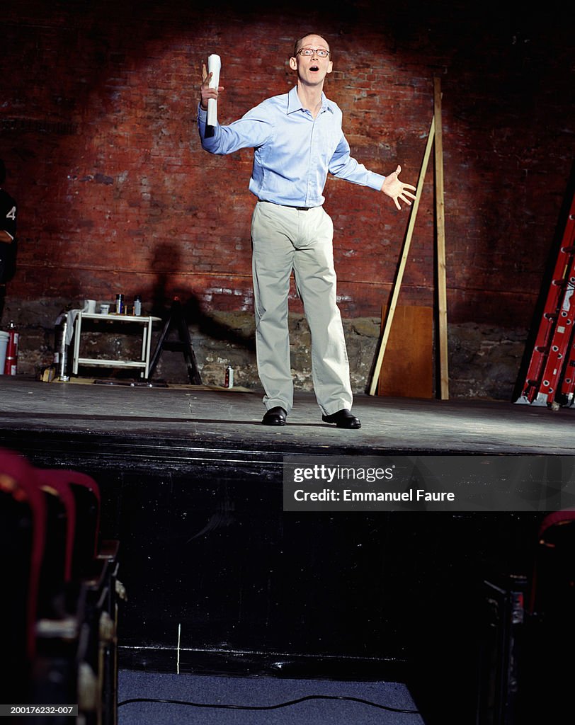 Man auditioning on stage in theater