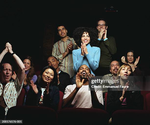 group of people in theater applauding and smiling - theater stock-fotos und bilder