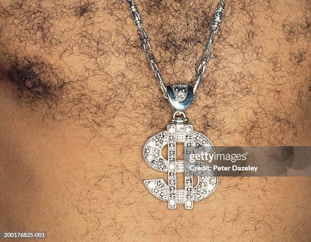 hairy chested man wearing us dollar sign medallion, close-up - hairy chest stock-fotos und bilder