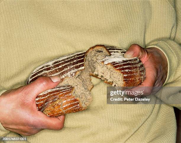 man breaking loaf of bread, mid section - breaking bread stock pictures, royalty-free photos & images