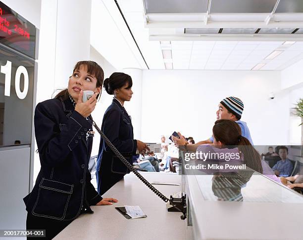 young couple at airport check in counter - public address system stock pictures, royalty-free photos & images