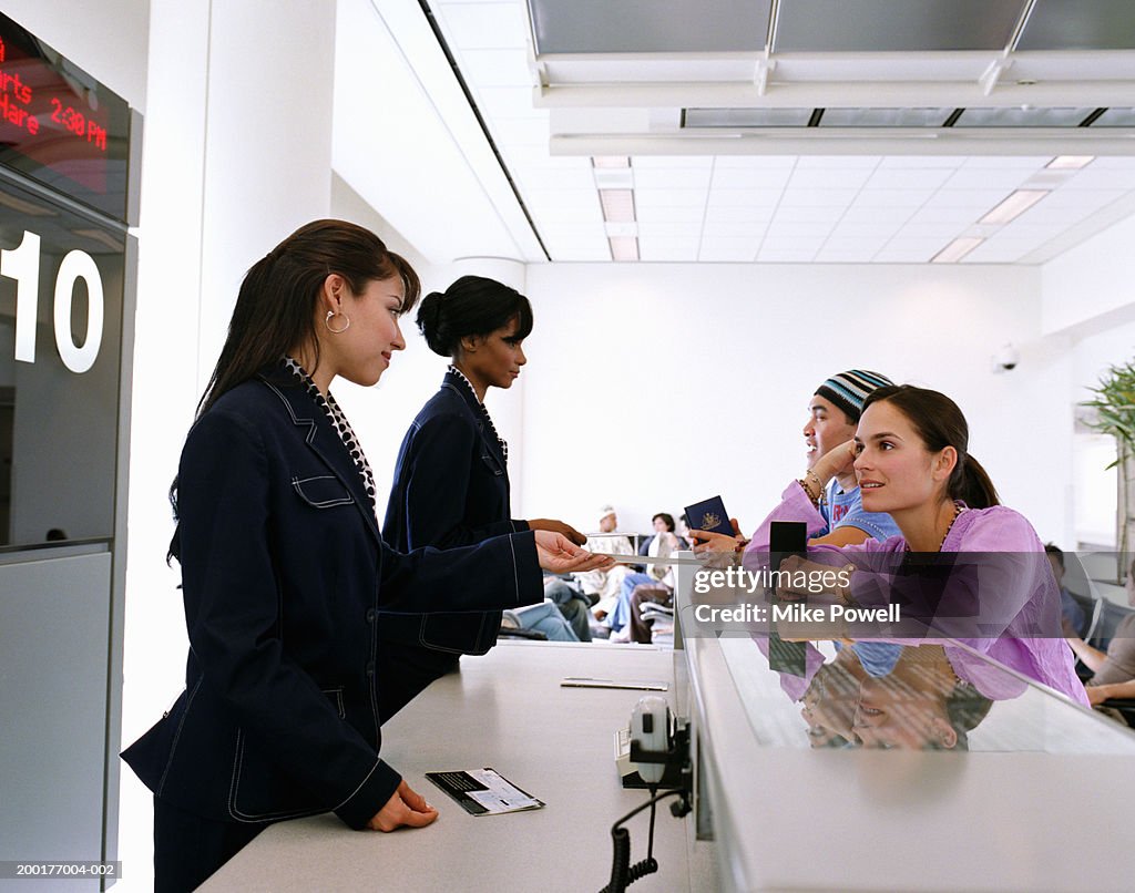 Young man and woman at airport check in counter