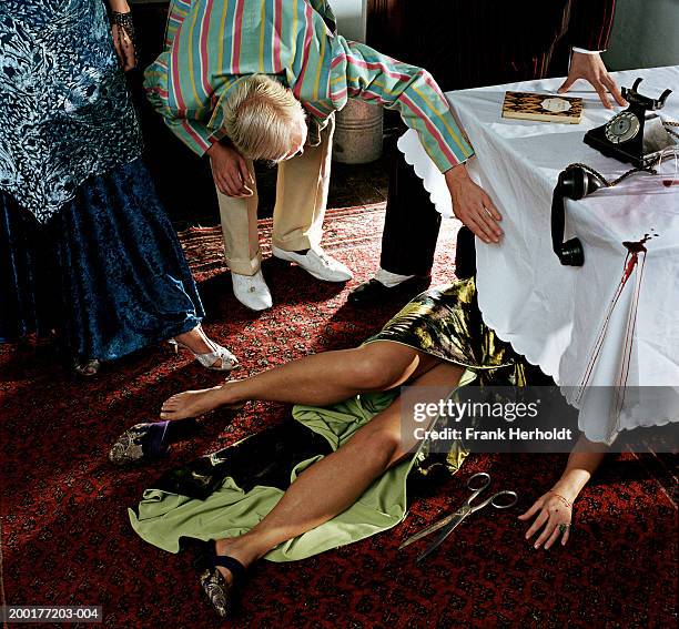 adults in fancy dress, man inspecting woman under dinner table - low section stockfoto's en -beelden