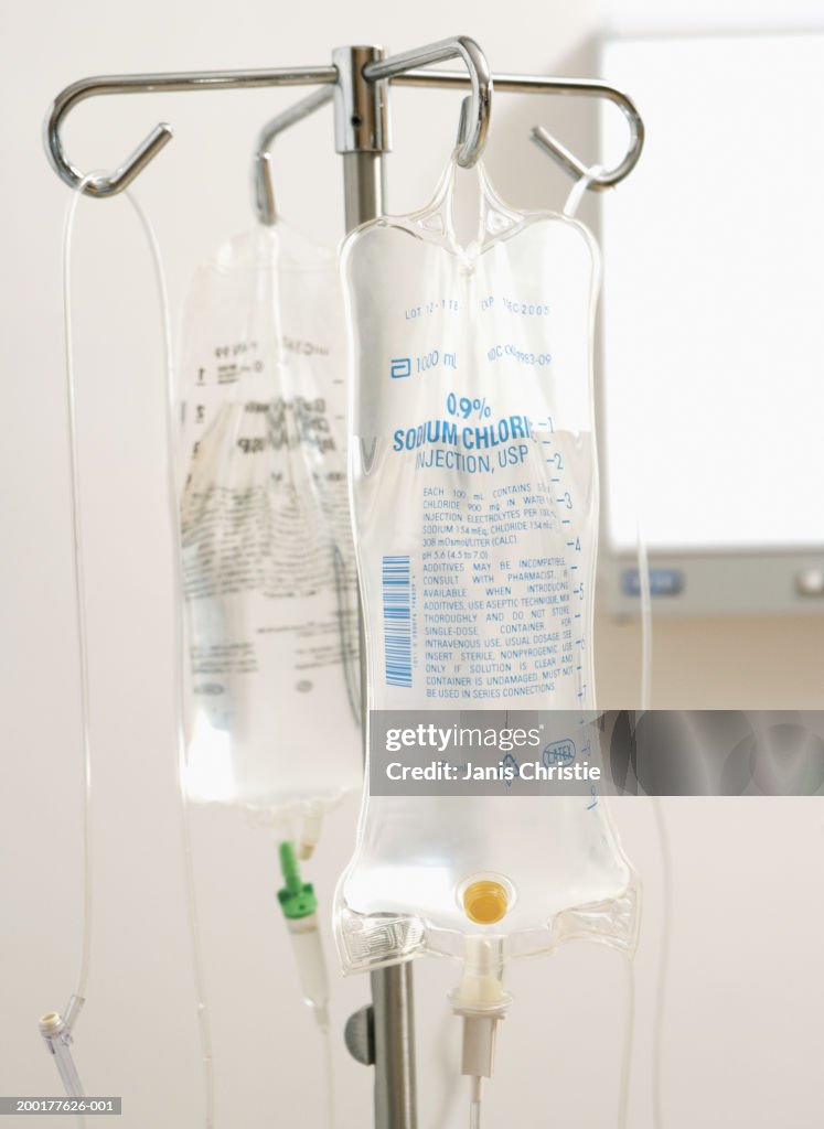 Saline drip (focus on bag of saline solution in foreground)