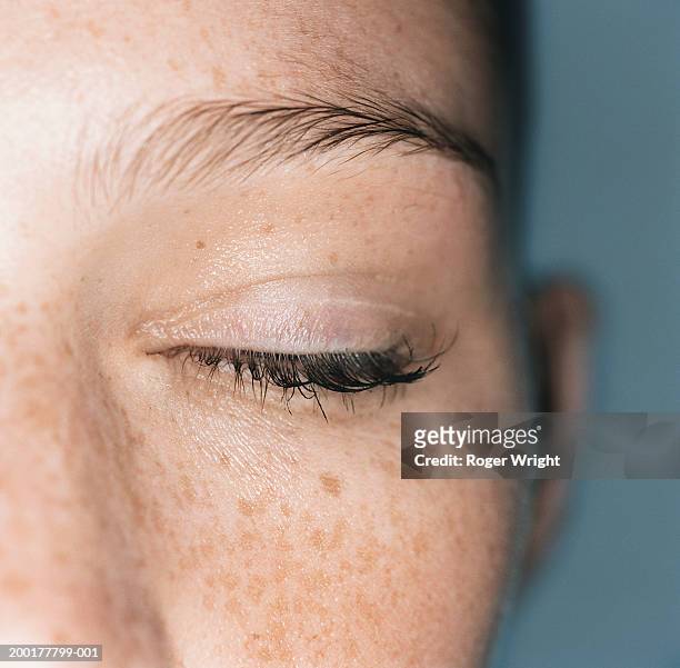 young woman with closed eye, close-up - man closed eyes stock-fotos und bilder