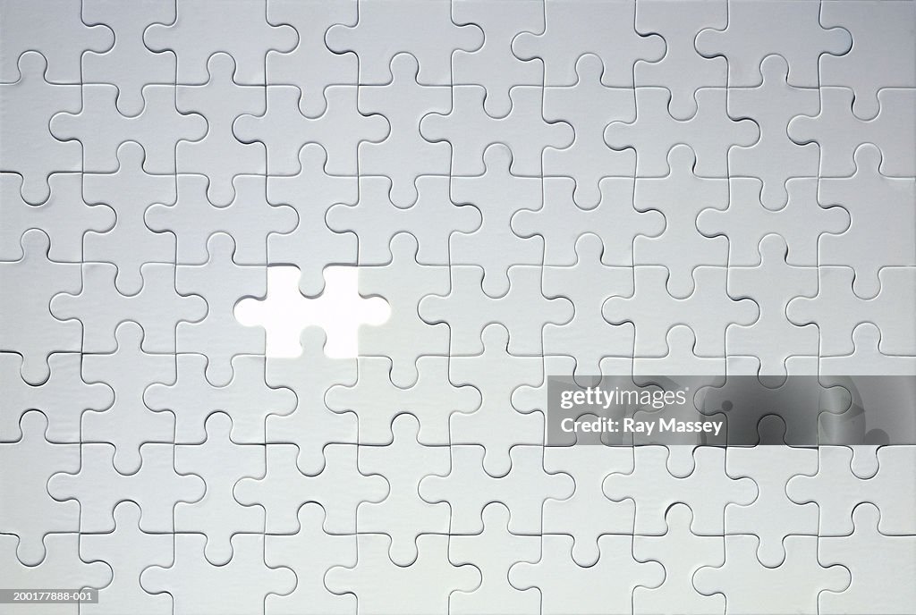 Piece missing from grey jigsaw puzzle