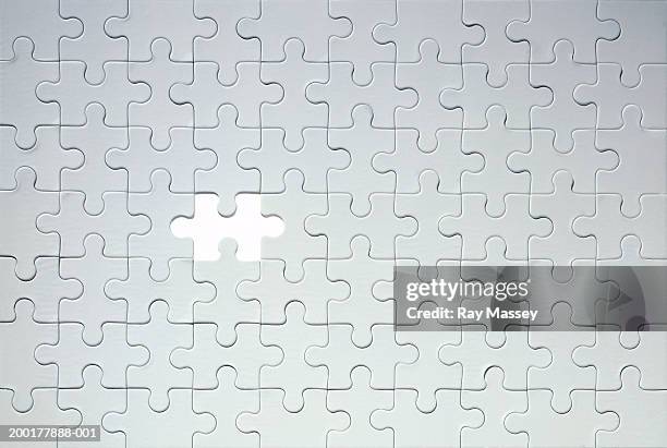 piece missing from grey jigsaw puzzle - incomplete bildbanksfoton och bilder