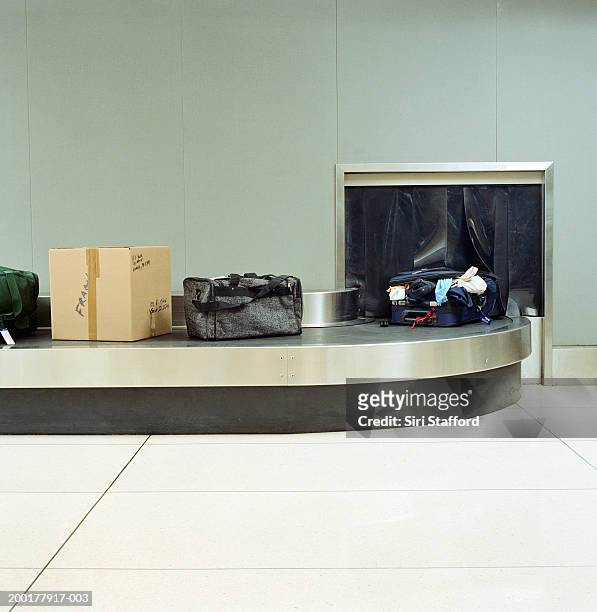 opened luggage on airport carousel - carousel stock pictures, royalty-free photos & images