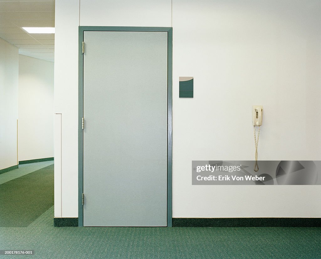 Door and telephone in building hallway