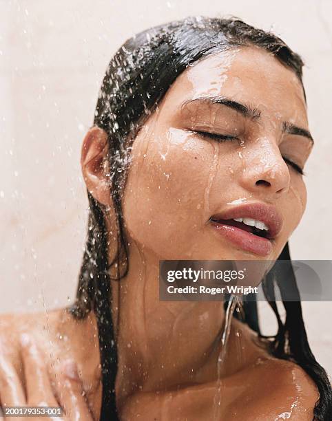 young woman under shower, eyes closed, close-up - nasses haar stock-fotos und bilder