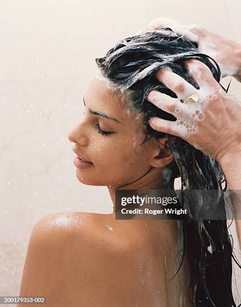 man washing young woman's hair, close-up - shower man woman washing stock pictures, royalty-free photos & images