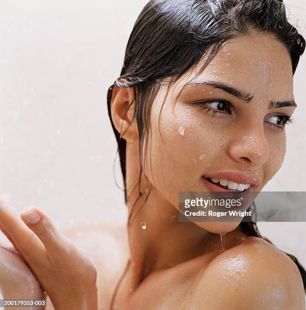 young woman under shower, smiling, close-up - wet hair fotografías e imágenes de stock