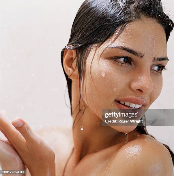 young woman under shower, smiling, close-up - wet hair stock pictures, royalty-free photos & images