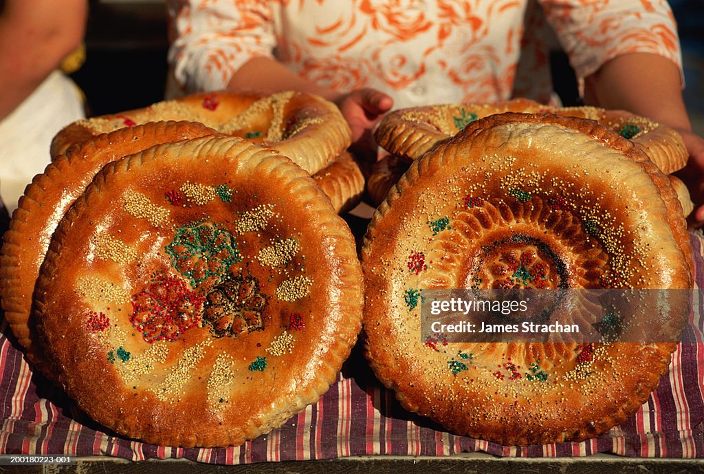 Woman by tray of baked bread