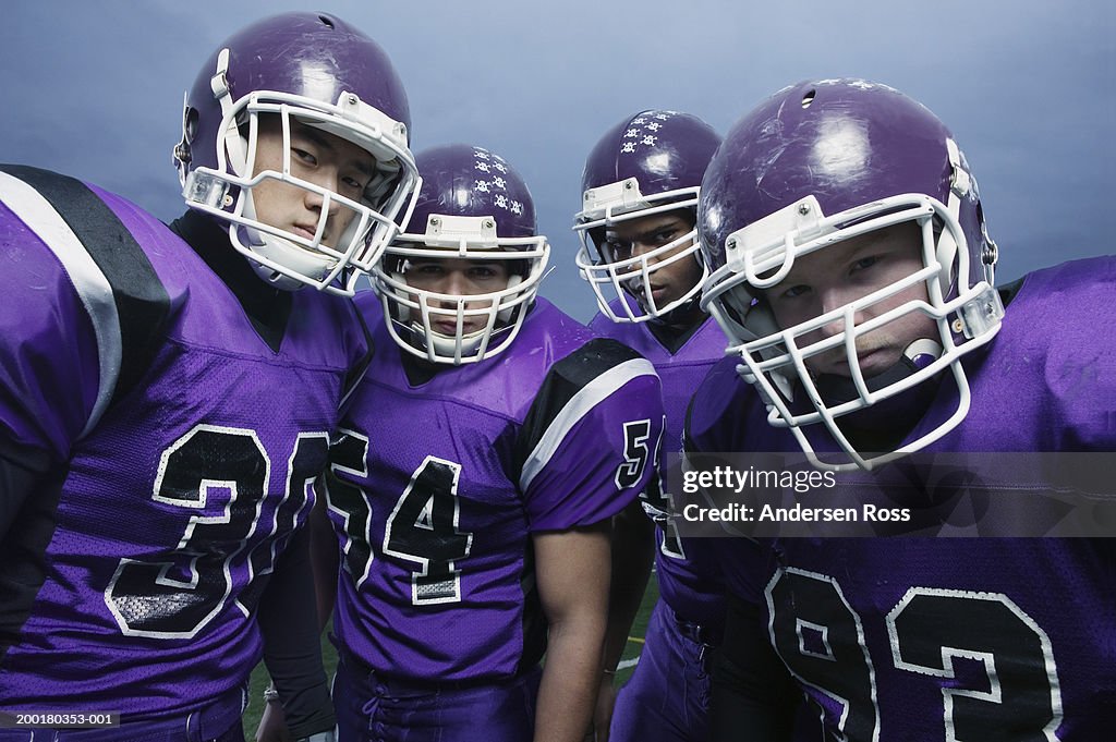 Four high school football players (16-18), portrait