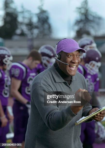 football coach cheering, wearing headset - coach cheering stock pictures, royalty-free photos & images