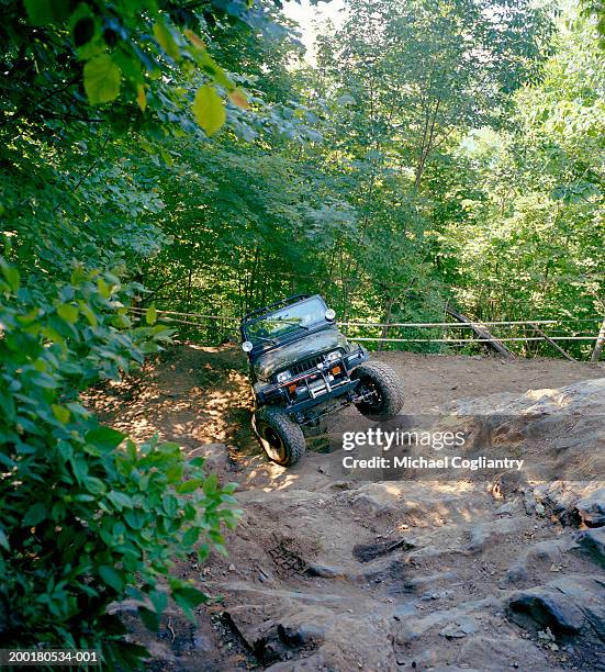 off road vehicle crossing woodland terrain - off highway vehicle stock pictures, royalty-free photos & images