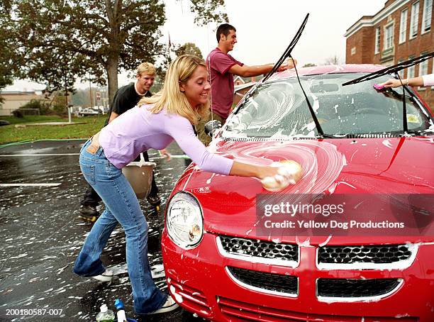 group of teenagers (17-19) washing car at charity  fundraiser - carwash stock pictures, royalty-free photos & images