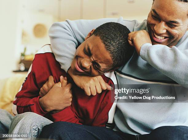 two brothers play fighting, smiling, close-up - brother stock pictures, royalty-free photos & images