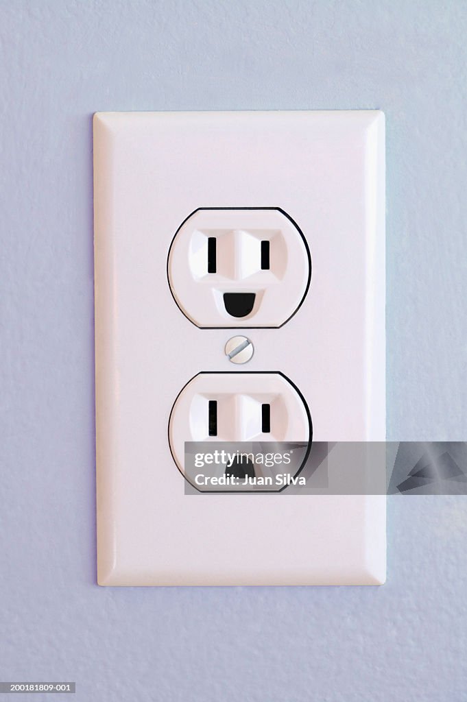 Sad Outlets Outlet On Wall With Happy And Sad Face High-Res Stock Photo - Getty Images