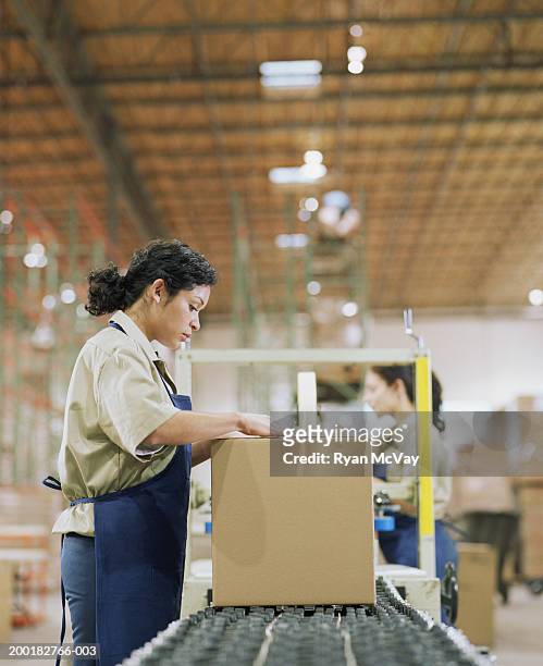 female warehouse worker packaging box - production line work stock pictures, royalty-free photos & images