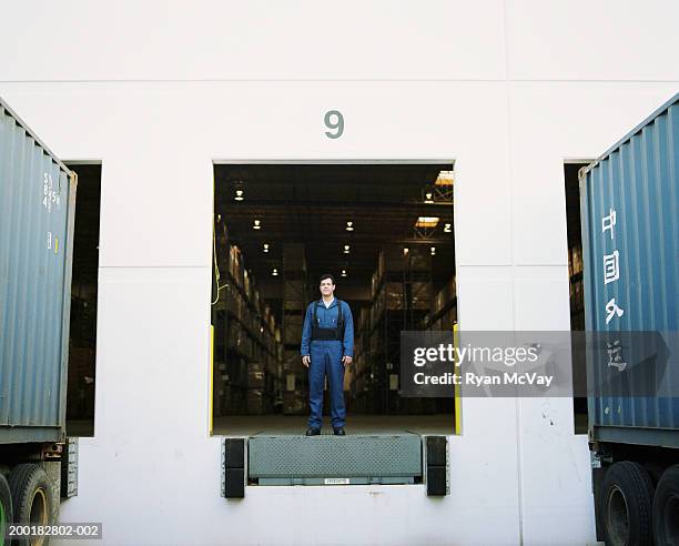 warehouse worker standing at loading dock - loading bay stock pictures, royalty-free photos & images