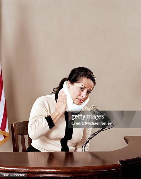 woman with neck brace testifying in court - witness fotografías e imágenes de stock