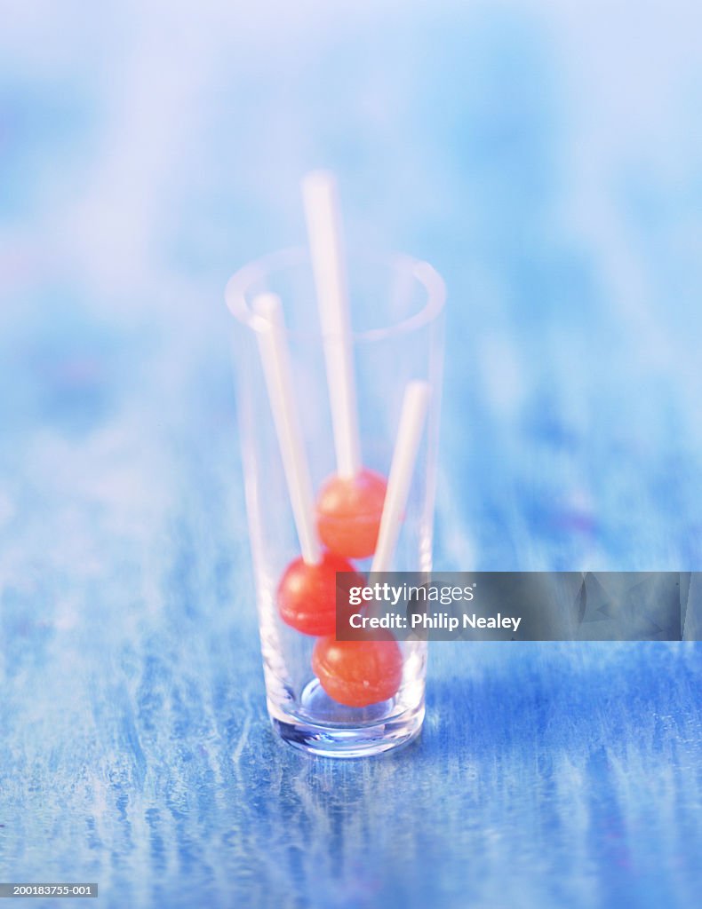 Three lollipops in glass