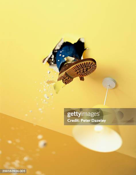 man's foot breaking through ceiling, low angle view - 概念與主題 個照片及圖片檔