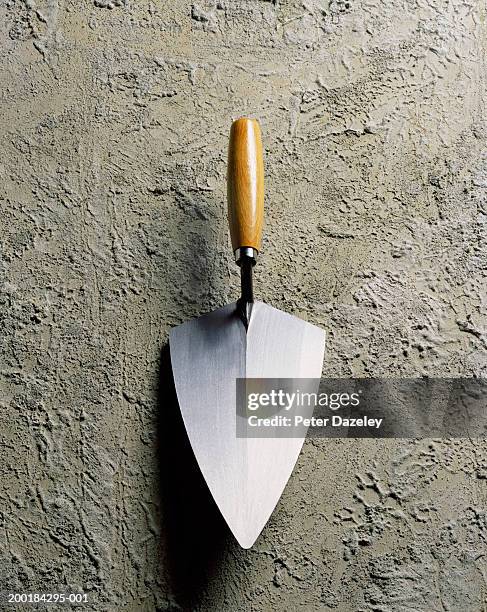 trowel placed on rough cement, close-up - trowel stock pictures, royalty-free photos & images